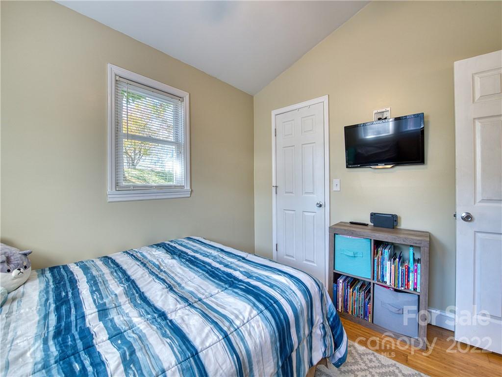 550 Lickstone Road Waynesville, NC 28786 - Photo 23 of 24 a bedroom with a bed and a flat screen tv