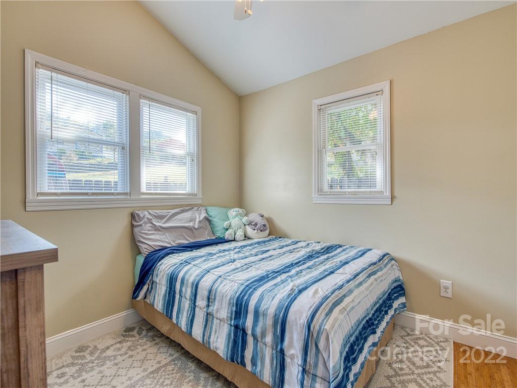 550 Lickstone Road Waynesville, NC 28786 - Photo 24 of 24 a bedroom with a bed next to a window