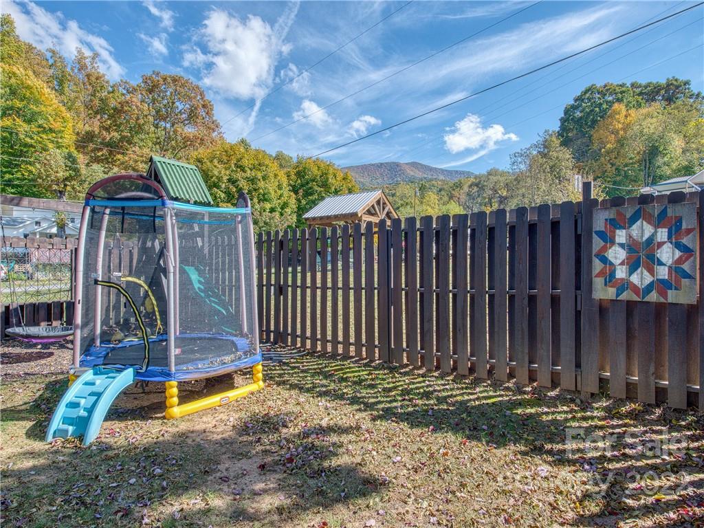 550 Lickstone Road Waynesville, NC 28786 - Photo 6 of 24 a view of a backyard with wooden fence