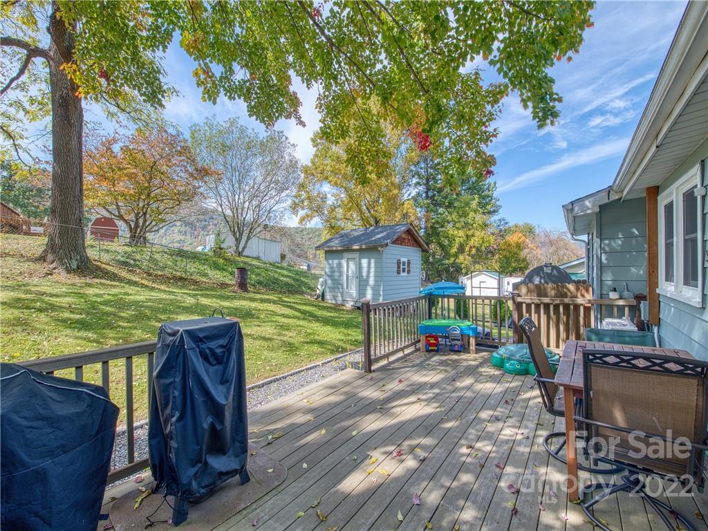 550 Lickstone Road Waynesville, NC 28786 - Photo 8 of 24 a view of a deck with furniture and garden
