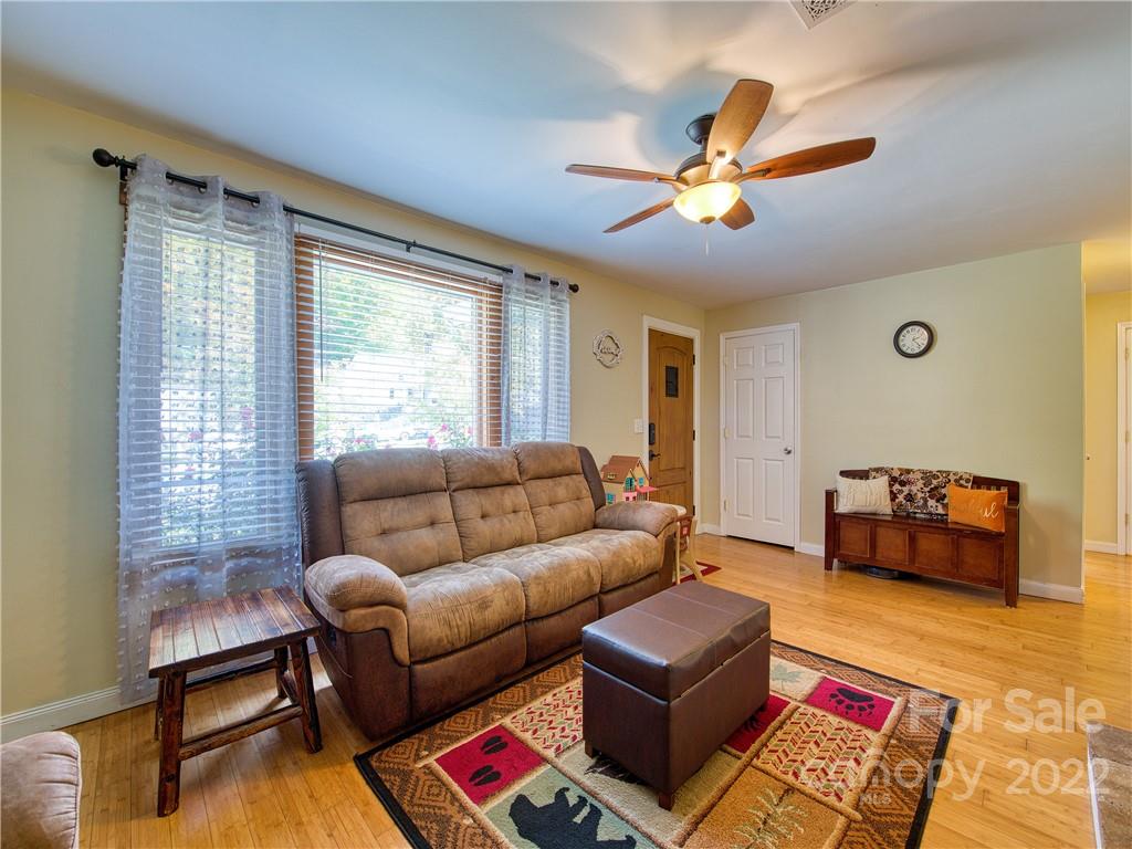 550 Lickstone Road Waynesville, NC 28786 - Photo 10 of 24 a living room with furniture and a flat screen tv