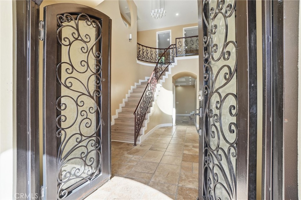 127 West 219th Place Carson, CA 90745 - Photo 2 of 69 Craftsmanship wrought iron double door entry with operable glass panels for airflow and easy cleaning.
