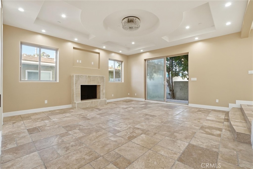 127 West 219th Place Carson, CA 90745 - Photo 5 of 69 Ambience is everything! Living room has a fireplace, powder room, sliding glass door leading to the back yard and two stairs up to the kitchen for easy access to the popcorn and snacks.