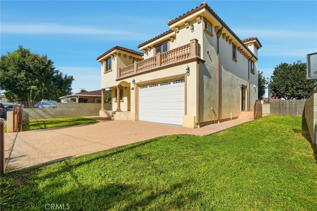 127 West 219th Place Carson, CA 90745 - Photo 52 of 69 Driveway, two car garage with high ceilings, and side yard.