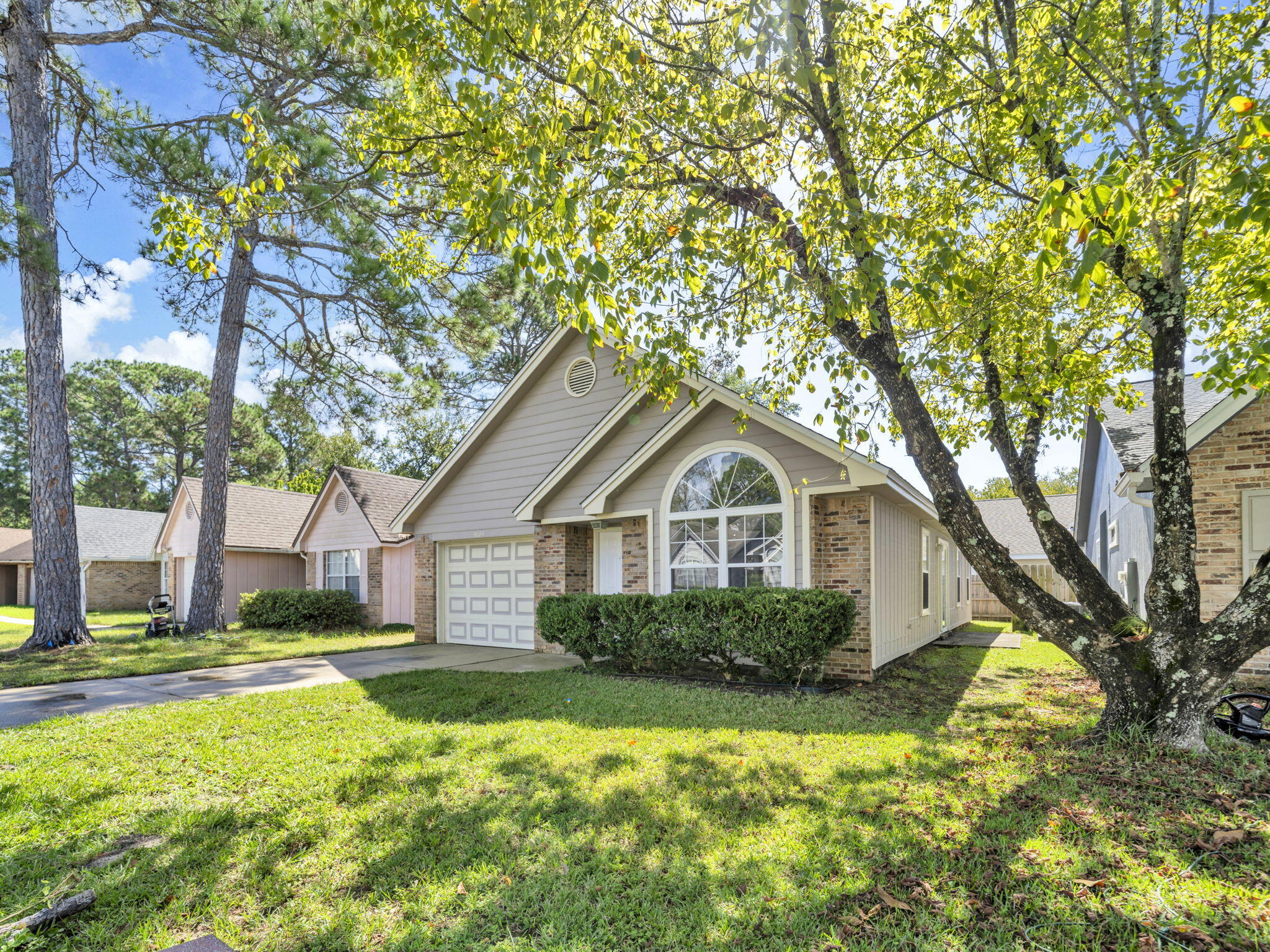 3024 Yorktown Circle Fort Walton Beach, FL 32547 - Photo 2 of 24 a front view of a house with a yard and garage