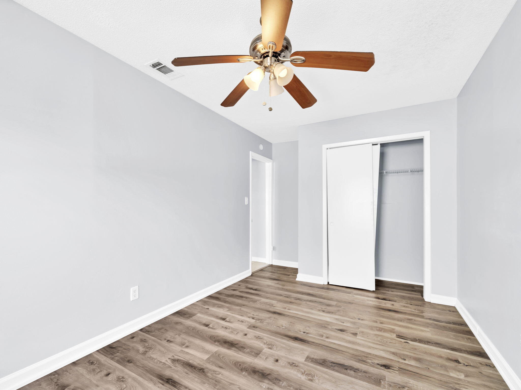3024 Yorktown Circle Fort Walton Beach, FL 32547 - Photo 21 of 24 a view of an empty room with wooden floor