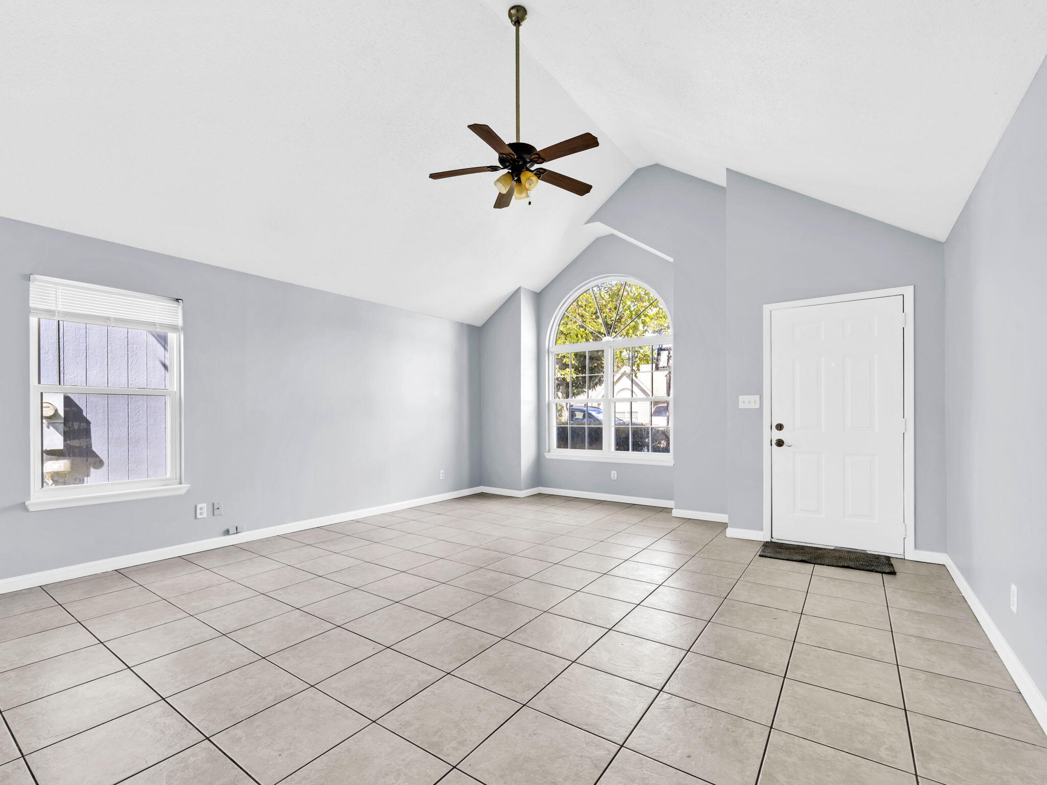 3024 Yorktown Circle Fort Walton Beach, FL 32547 - Photo 6 of 24 an empty room with windows and fan