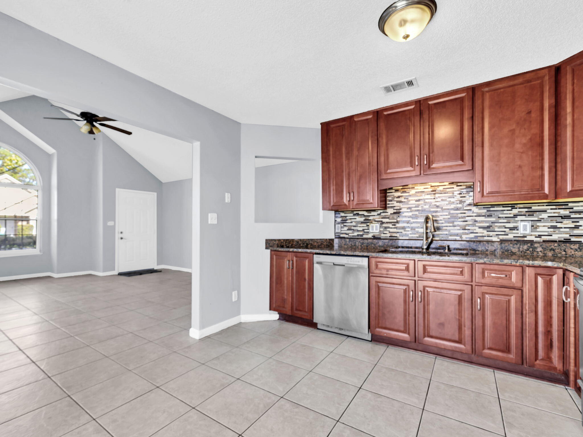 3024 Yorktown Circle Fort Walton Beach, FL 32547 - Photo 10 of 24 a kitchen with stainless steel appliances granite countertop a sink dishwasher stove and cabinets