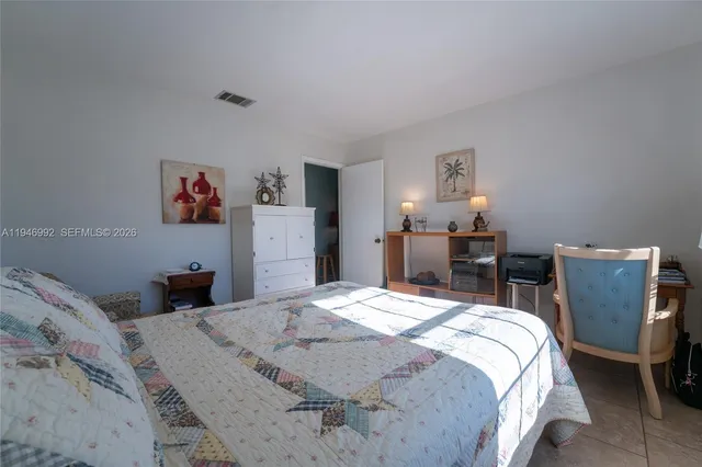 a bedroom with a bed and a dresser in it