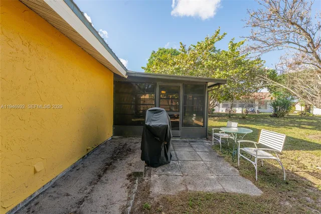 a front view of a house with garden and patio