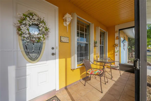 an entryway with a table and chairs