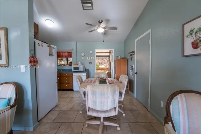 a dining room with furniture and chandelier