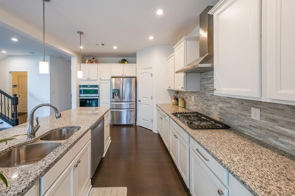 5116 Barton Pass Northwest Acworth, GA 30101 - Photo 12 of 42 a kitchen with stainless steel appliances granite countertop a sink stove and refrigerator