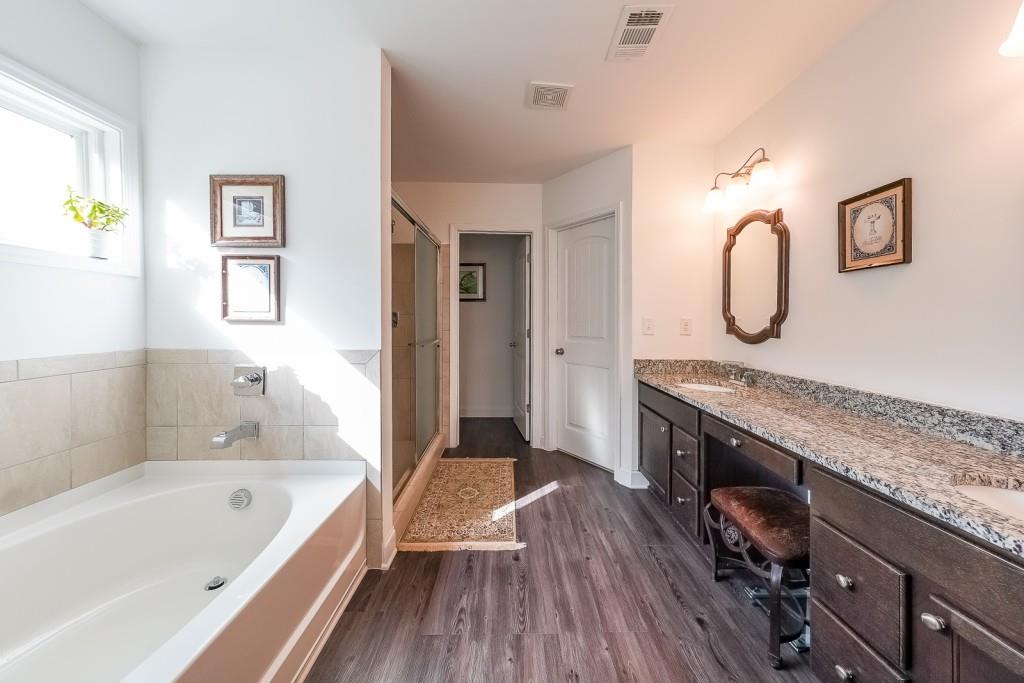 5116 Barton Pass Northwest Acworth, GA 30101 - Photo 17 of 42 a spacious bathroom with a granite countertop tub sink and mirror