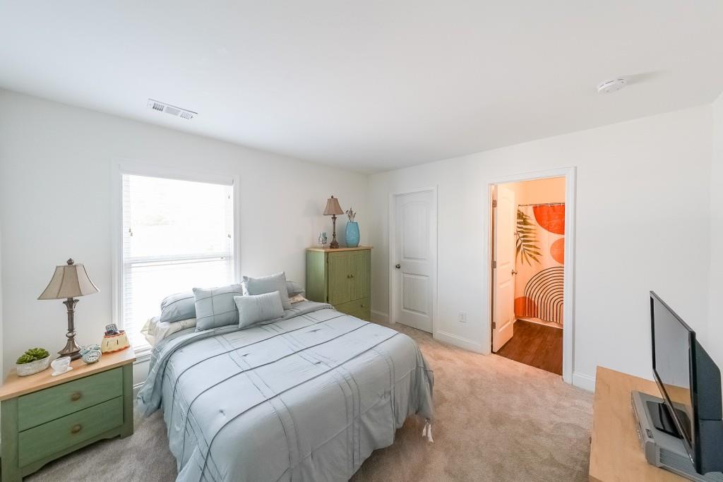 5116 Barton Pass Northwest Acworth, GA 30101 - Photo 22 of 42 a bedroom with a bed and a flat tv screen on the dresser