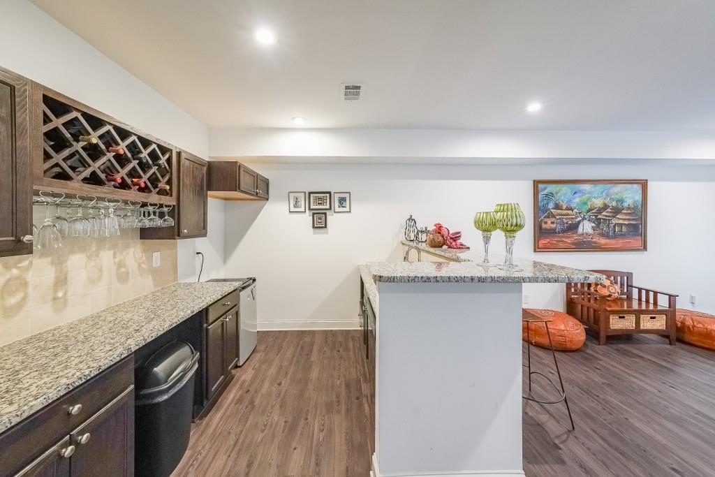 5116 Barton Pass Northwest Acworth, GA 30101 - Photo 28 of 42 a kitchen with stainless steel appliances granite countertop a sink stove and wooden floor