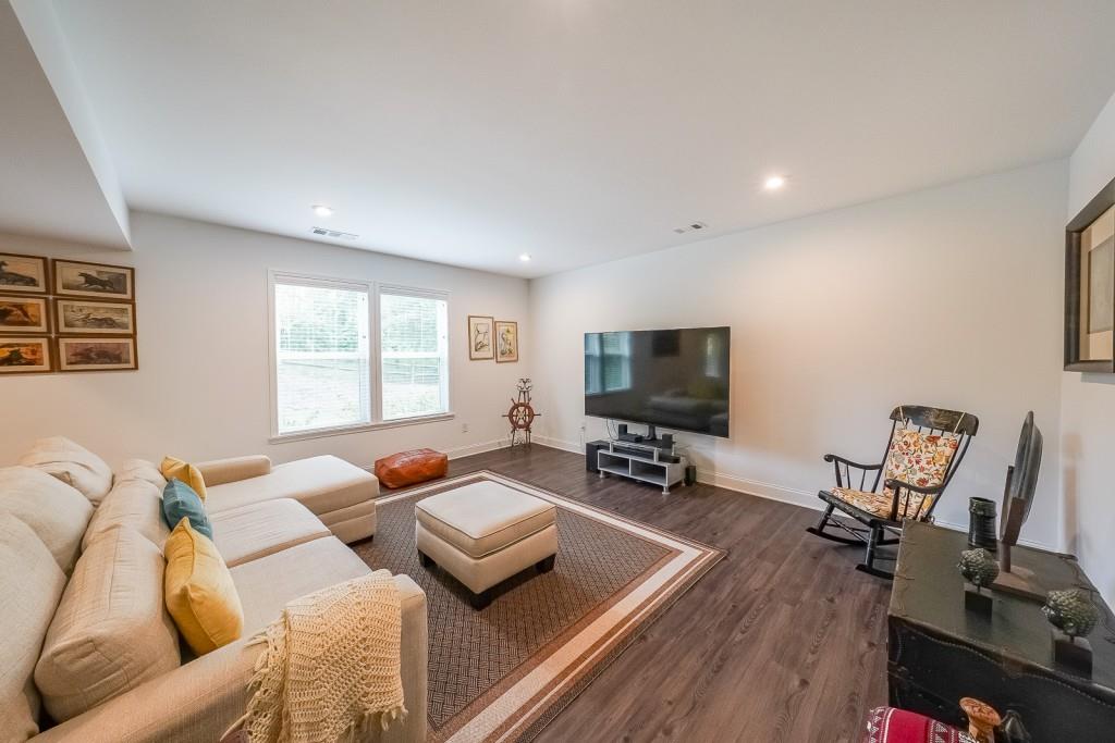 5116 Barton Pass Northwest Acworth, GA 30101 - Photo 30 of 42 a living room with furniture a flat screen tv and a window