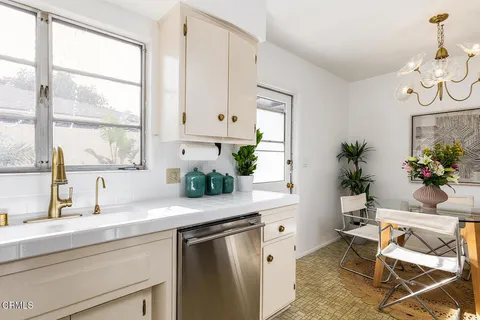 a kitchen with a sink cabinets and window