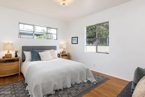 a large bed sitting in a bedroom next to a window