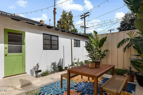 a view of a house with backyard and sitting area