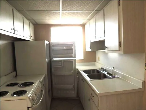 a kitchen that has a sink and a stove