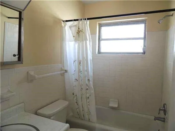 a bathroom with a toilet and shower