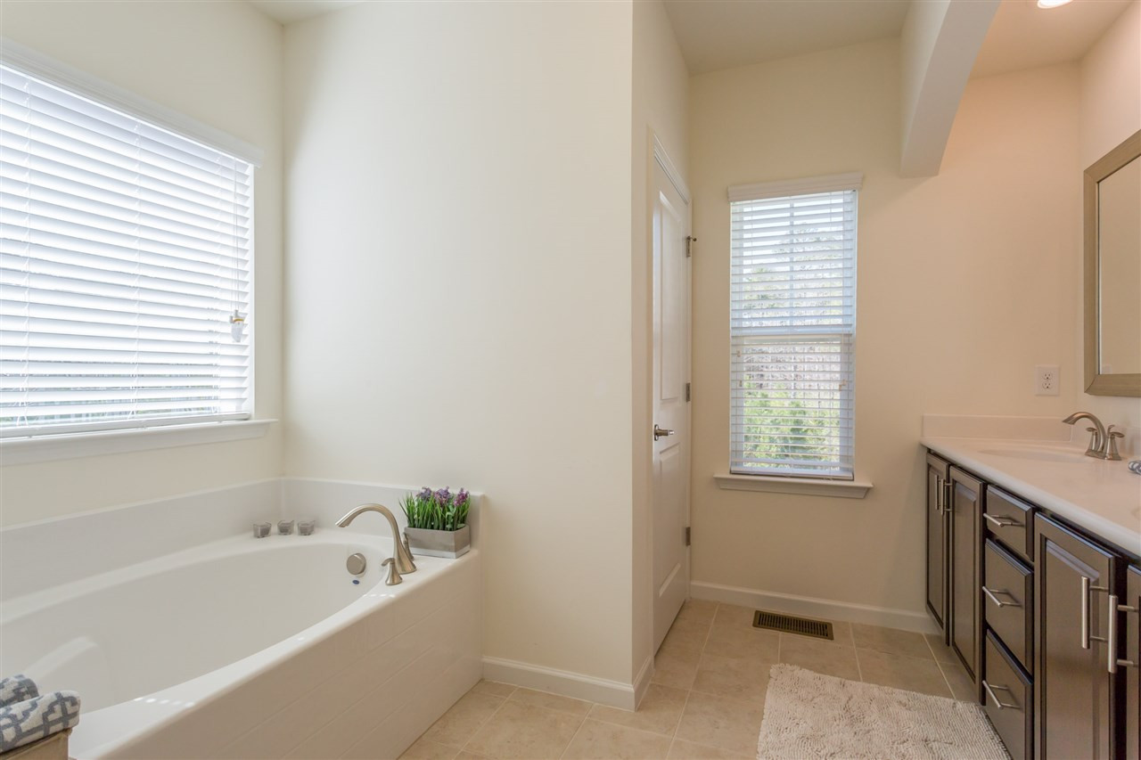 605 Edgewater Ridge Court Apex, NC 27523 - Photo 13 of 25 Master bath has dual-sink vanity, soaking tub, separate shower, and the all-important, private water closet.