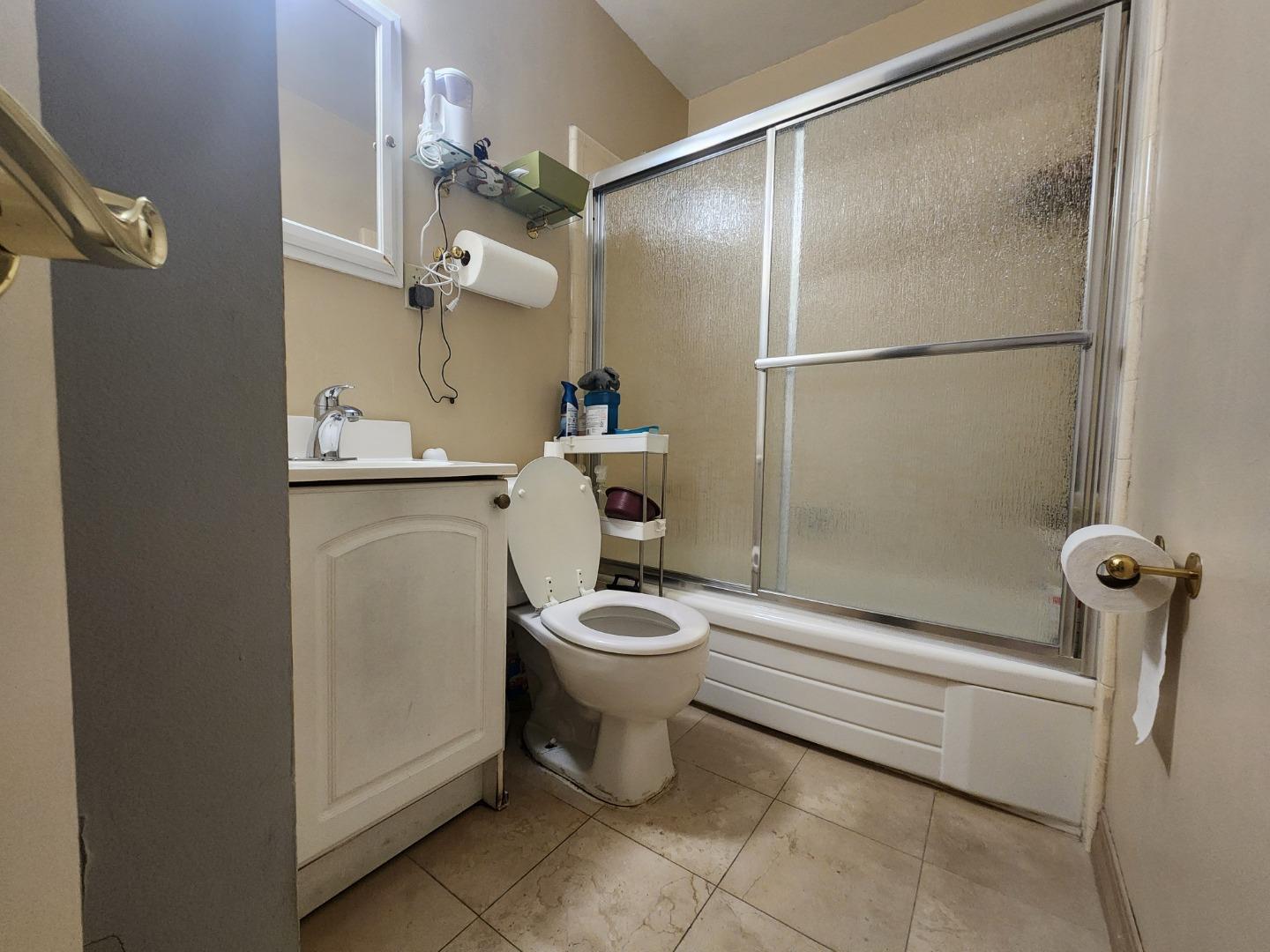 1240 4th Street San Rafael, CA 94901 - Photo 3 of 12 a bathroom with a granite countertop sink mirror vanity and toilet