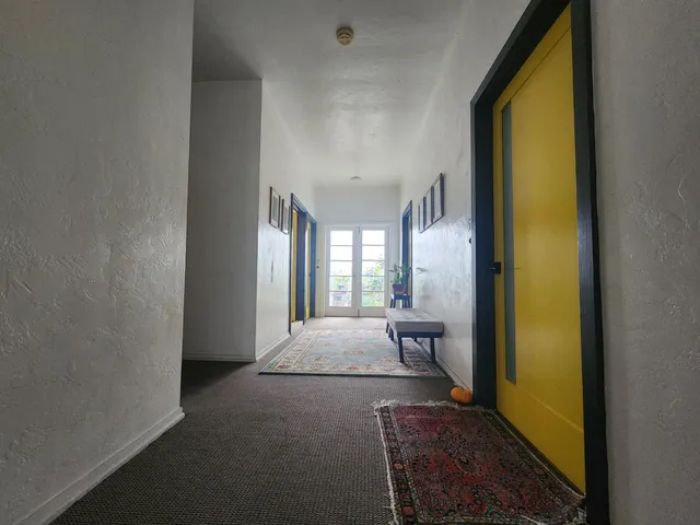 a kitchen with a refrigerator and a stove top oven