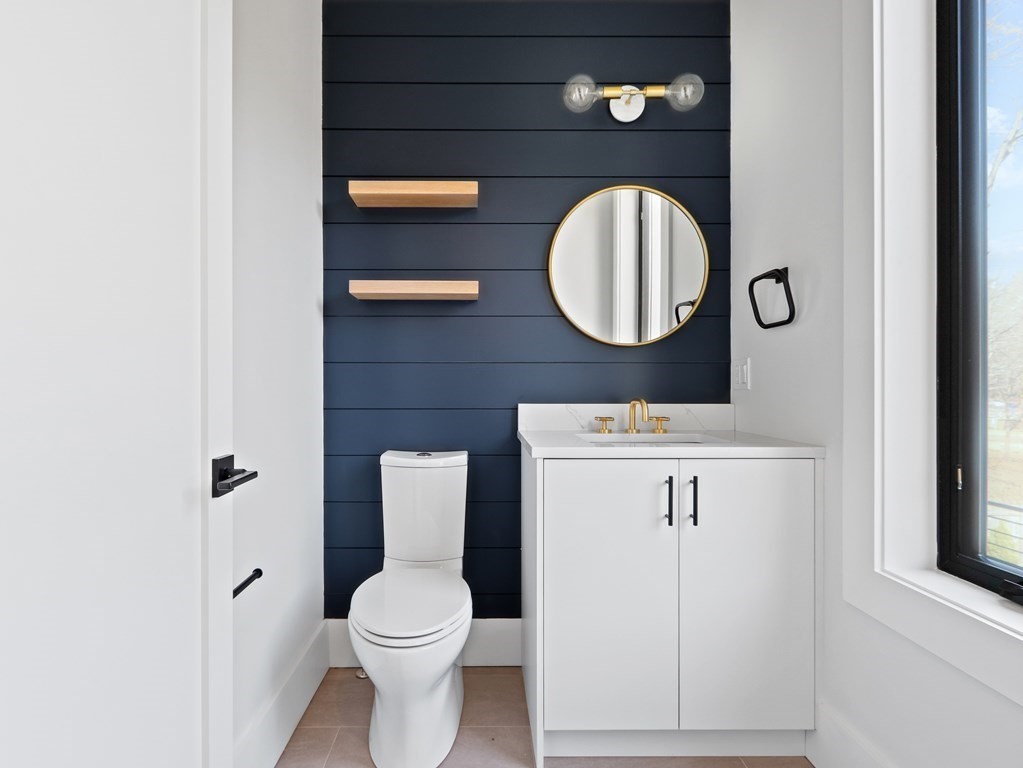27 Nightingale Path Newton, MA 02459 - Photo 12 of 13 a bathroom with a toilet a sink and a mirror