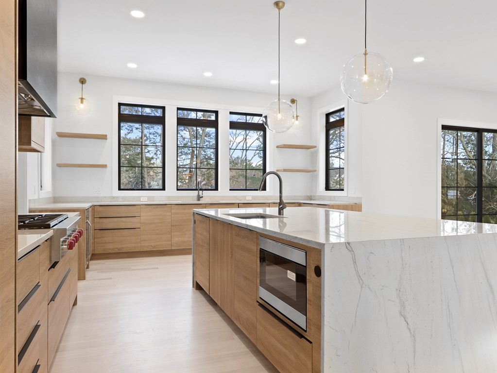 27 Nightingale Path Newton, MA 02459 - Photo 4 of 13 a large kitchen with stainless steel appliances granite countertop a stove a sink and a refrigerator