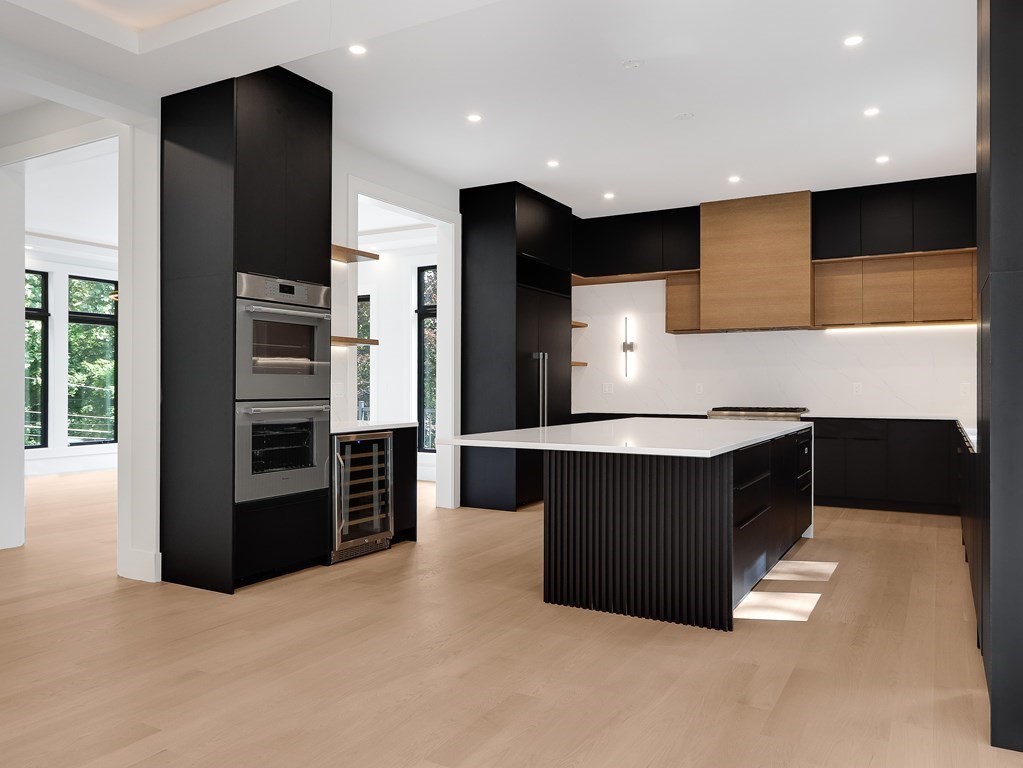 27 Nightingale Path Newton, MA 02459 - Photo 5 of 13 a kitchen with stainless steel appliances kitchen island granite countertop a refrigerator and a stove top oven