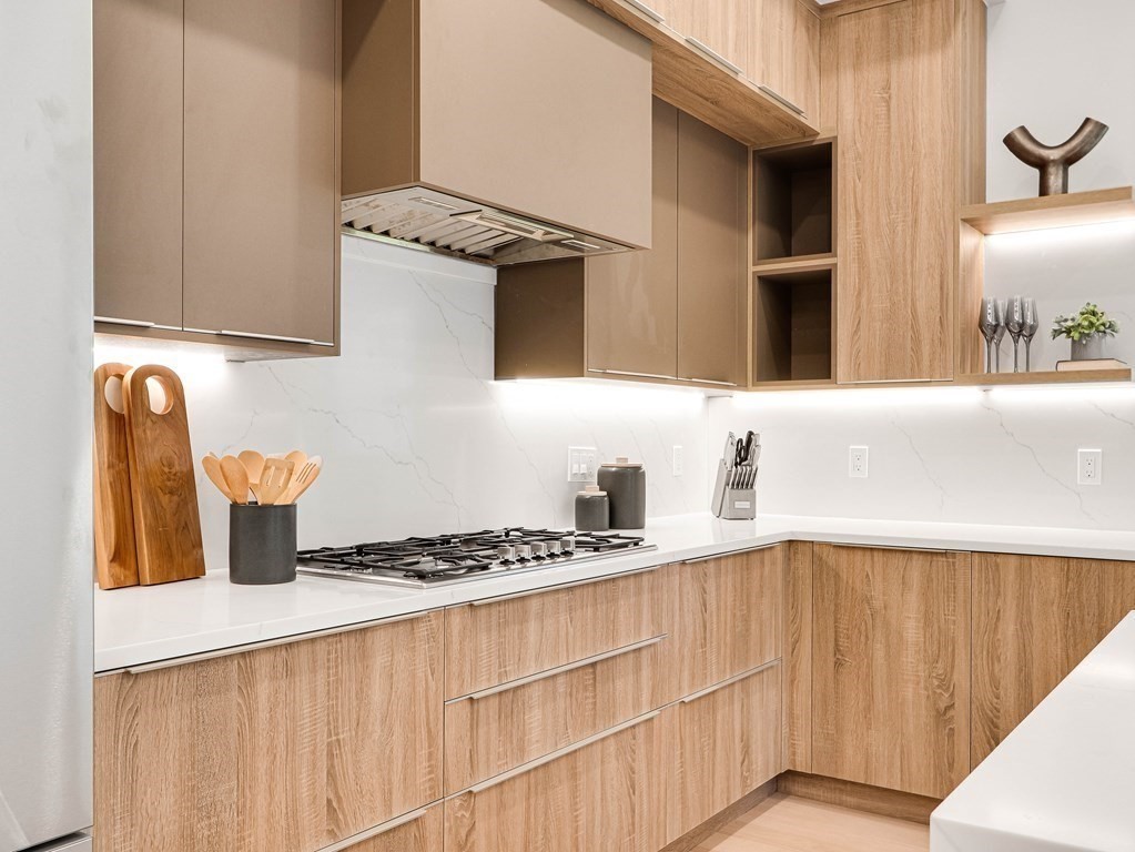 27 Nightingale Path Newton, MA 02459 - Photo 6 of 13 a kitchen with stainless steel appliances granite countertop a sink stove and cabinets