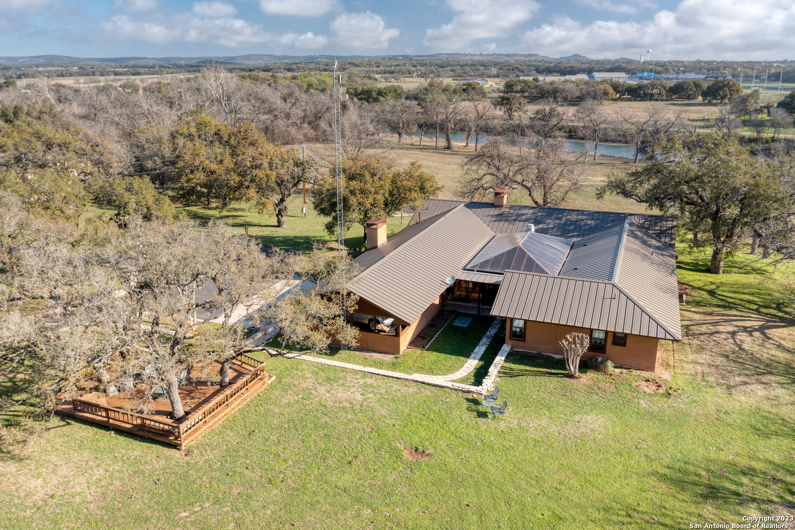 610 Kendalia Road Blanco, TX 78606 - Photo 1 of 1 an aerial view of a house with a yard and lake view