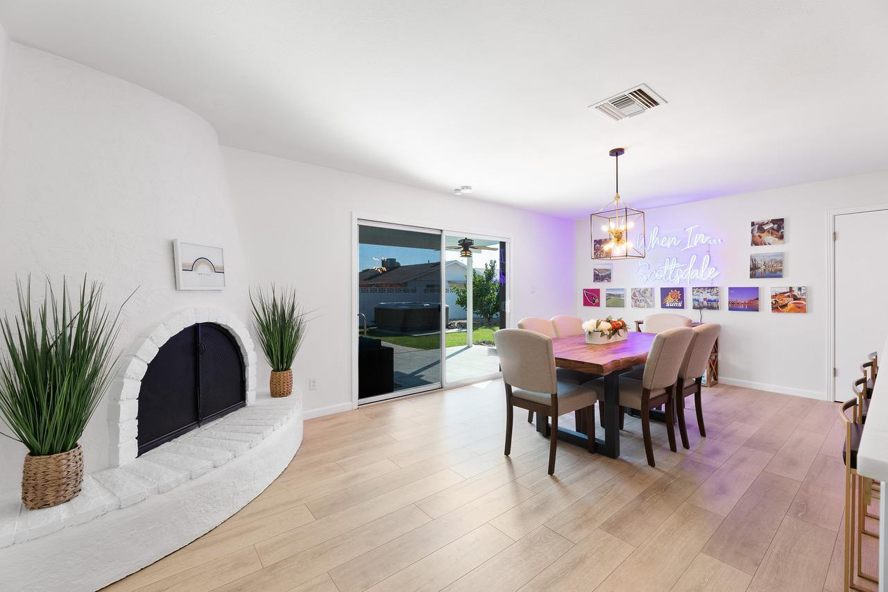 8307 East Arlington Road Scottsdale, AZ 85250 - Photo 10 of 25 a dining room with furniture potted plants and wooden floor