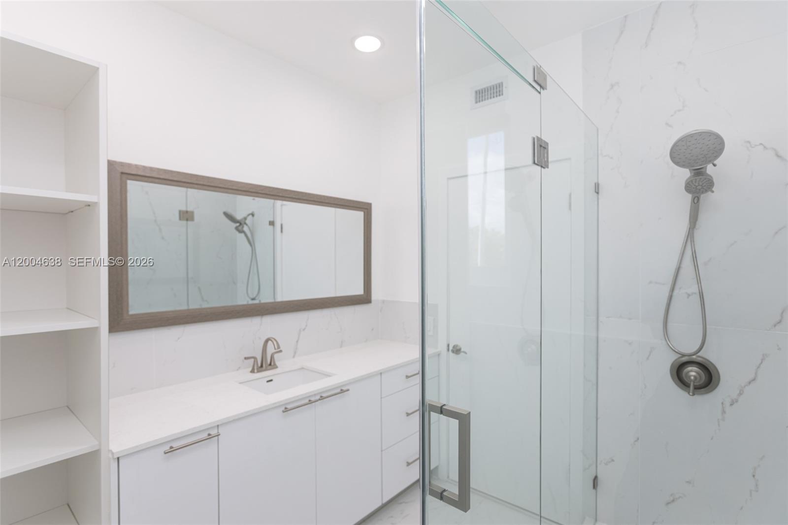 1690 Daytonia Road Miami Beach, FL 33141 - Photo 44 of 88 a bathroom with a granite countertop sink a shower and mirror