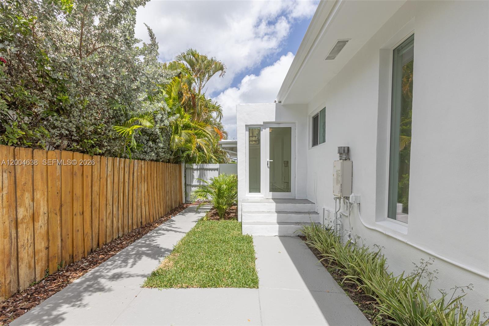 1690 Daytonia Road Miami Beach, FL 33141 - Photo 83 of 88 a view of a pathway with a white house