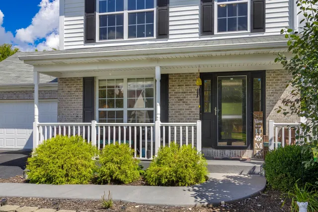 a view of a house with a small window and potted plants