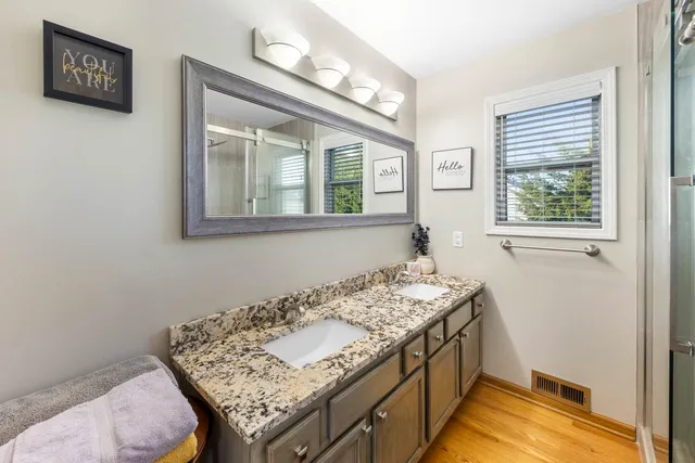 a bathroom with a sink a vanity and a window