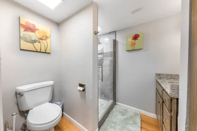 a white toilet sitting next to a bathroom sink
