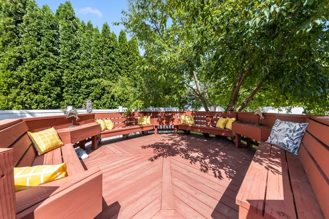 an outdoor sitting area with furniture and wooden floor