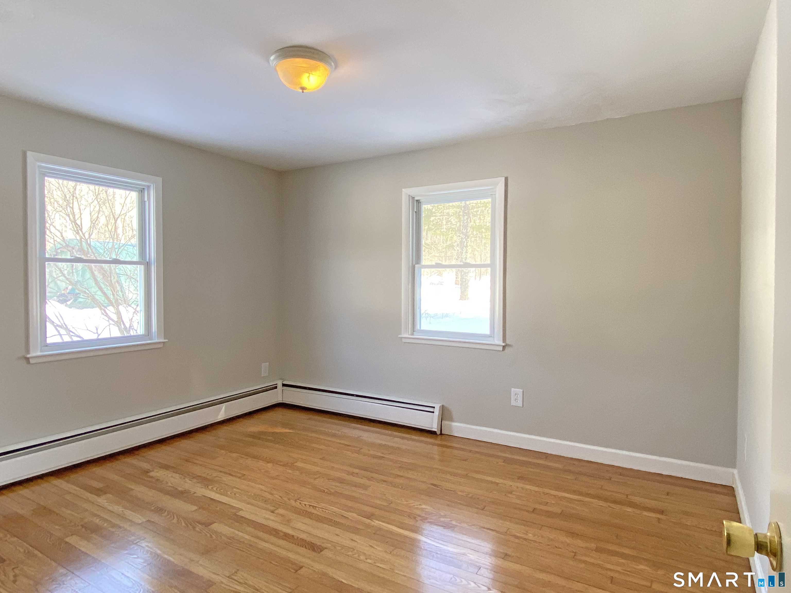 374 Torrington Road Litchfield, CT 06759 - Photo 16 of 28 a view of an empty room with wooden floor and a window
