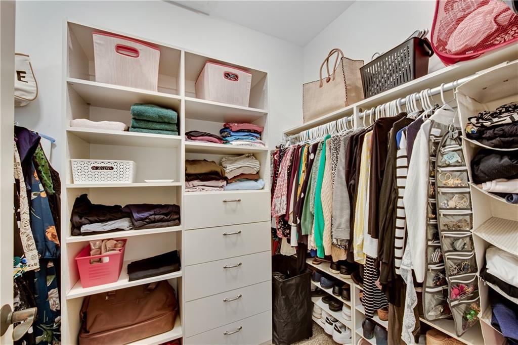 13942 Tree Loft Road Milton, GA 30004 - Photo 51 of 102 a view of walk in closet with clothes and shoes