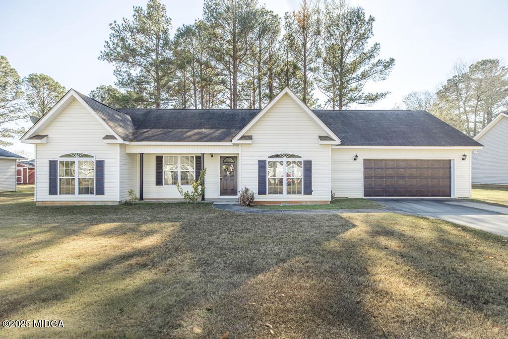 a view of a house with a yard and garage