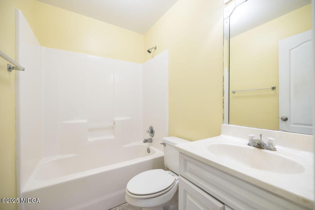 204 Chimney Rock Road Perry, GA 31069 - Photo 22 of 28 a bathroom with a bathtub shower sink vanity mirror and toilet