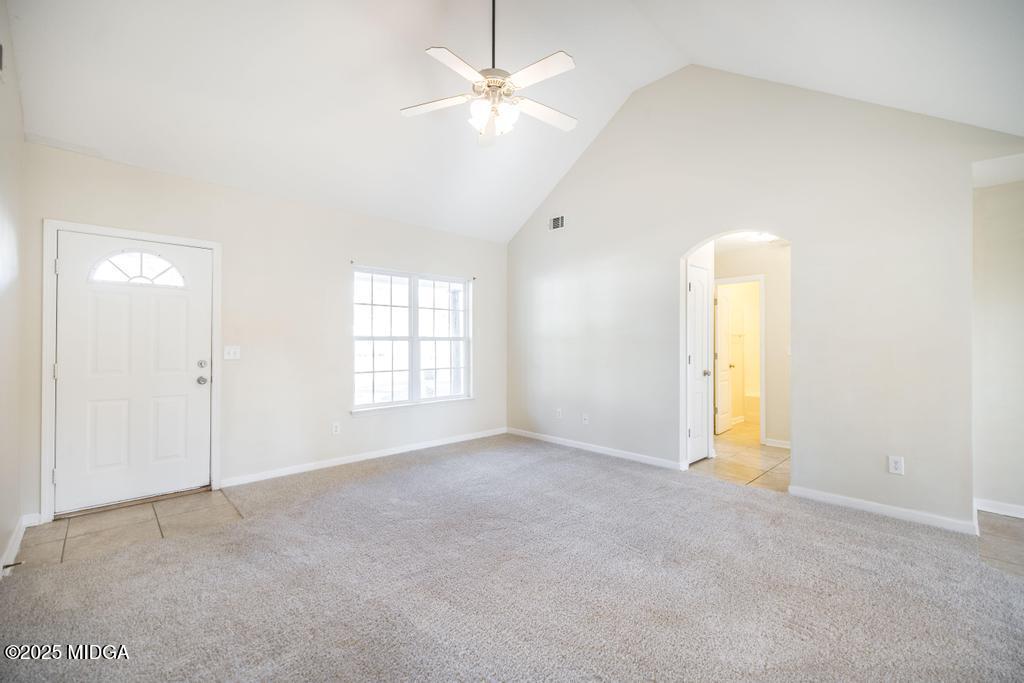 204 Chimney Rock Road Perry, GA 31069 - Photo 7 of 28 an empty room with a window and a ceiling fan