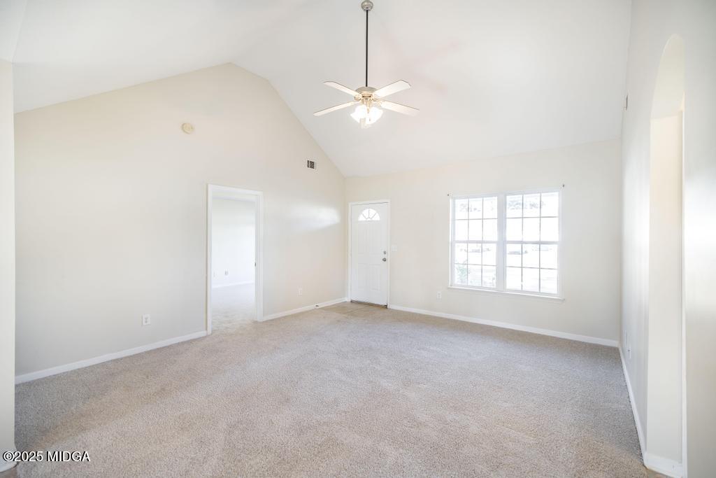 204 Chimney Rock Road Perry, GA 31069 - Photo 8 of 28 an empty room with windows and ceiling fan