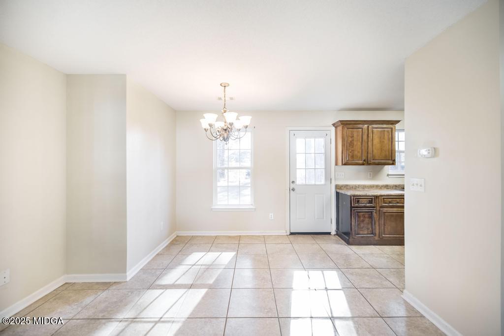204 Chimney Rock Road Perry, GA 31069 - Photo 9 of 28 an empty room with a fireplace and windows