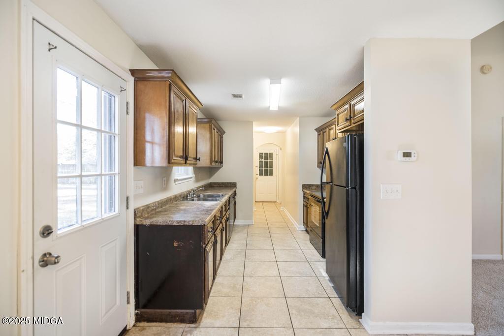 204 Chimney Rock Road Perry, GA 31069 - Photo 10 of 28 a kitchen with stainless steel appliances granite countertop a refrigerator and a sink