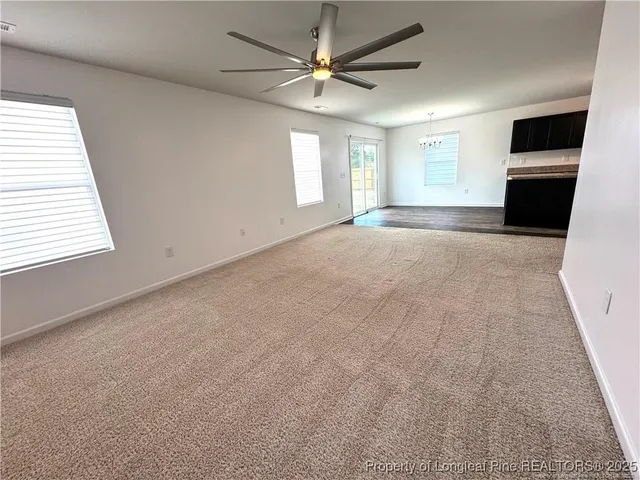 a open kitchen with kitchen island stainless steel appliances a stove a sink dishwasher a refrigerator and a fireplace with wooden floor